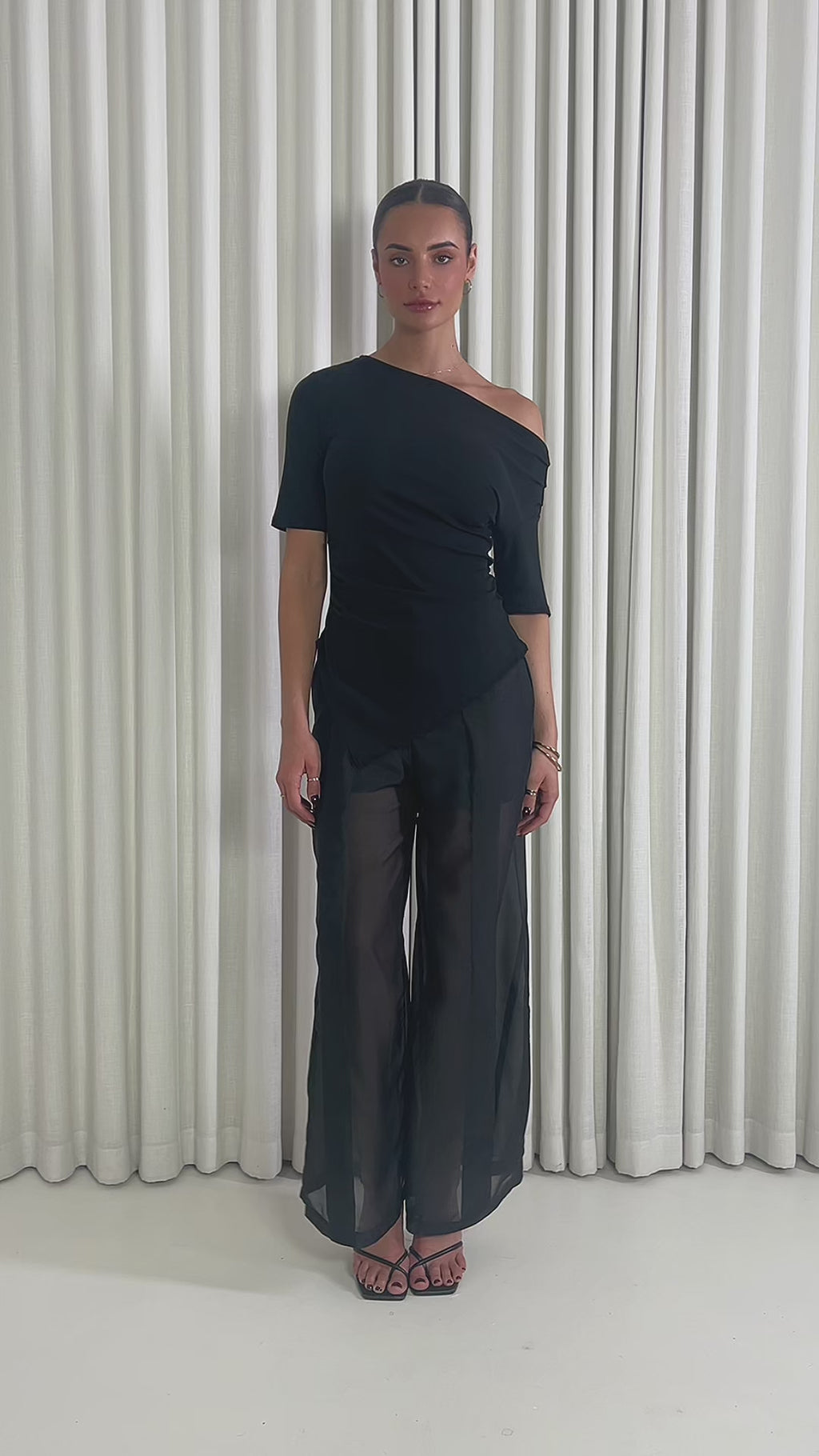 Black high waisted pants with sheer organza legs and shorts lining & Black off shoulder fitted top with gathered sides and asymmetrical hem