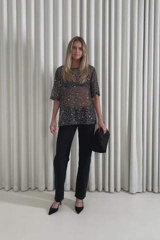 Model showing the Brook Sequin Top from the front, side and back to demonstrate its fit and movement.