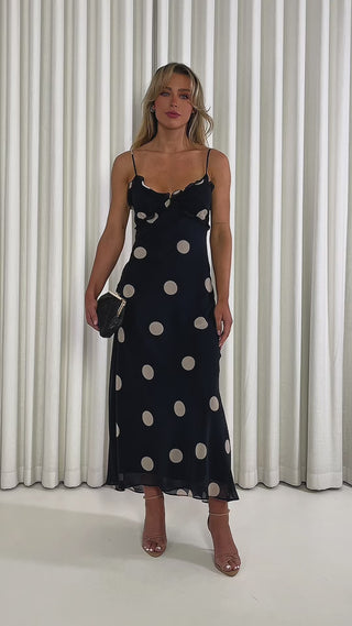 Black-polka-dot-midi-dress-with-V-neck-frill-bust-and-tie-back.jpg