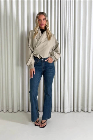 Model showing the Nathaniel wrap jacket and Daniel blue jeans from the front, side and back to demonstrate its fit and movement.