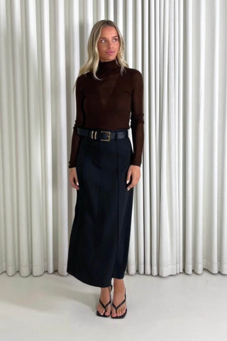 Model showing the Andy brown top and Theresa black midi skirt from the front, side and back to demonstrate its fit and movement.