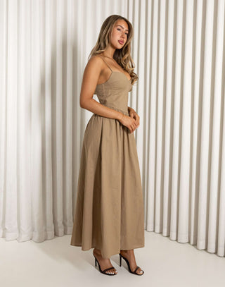Woman wearing a beige dress against a white curtain background Robin mocha fit-and-flare maxi dress with wireless cups
