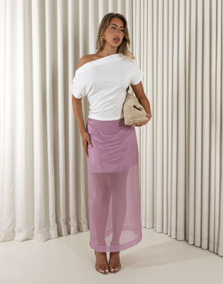 Woman wearing a white top and purple skirt against a white curtain background Romain purple sheer overlay midi skirt with mini lining
