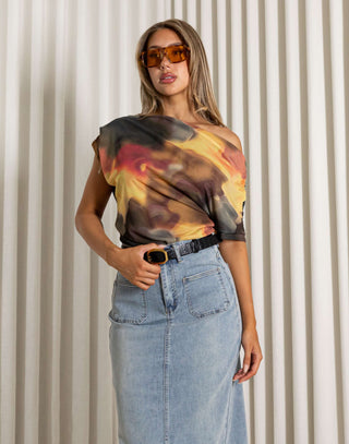 Woman wearing a colorful one-shoulder top and denim skirt against a neutral background Will off shoulder mesh print top, fitted waist
